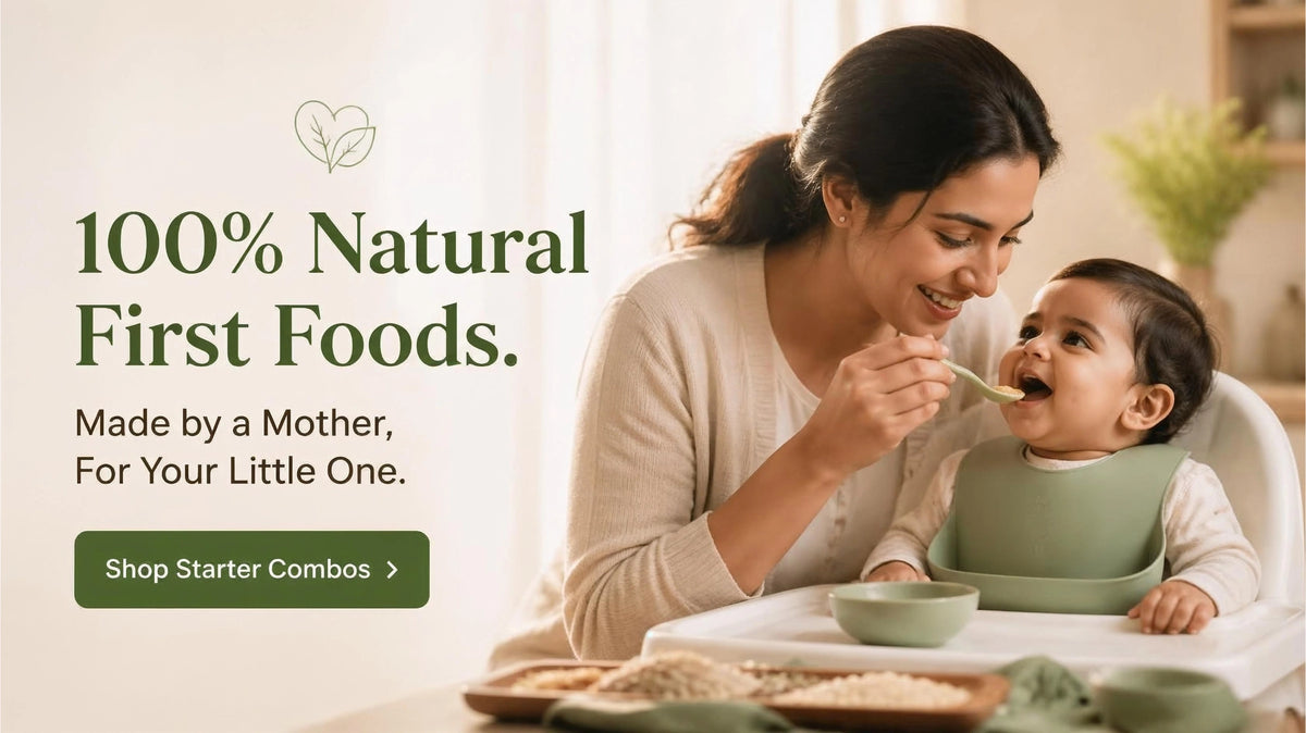 A woman feeding a baby in a high chair in a warm, bright kitchen setting, with text on the left reading '100% Natural First Foods. Made by a Mother, For Your Little One.